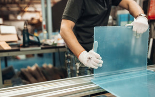 Acrylic Fabrication. Technician bends a clear plexiglass sheet.